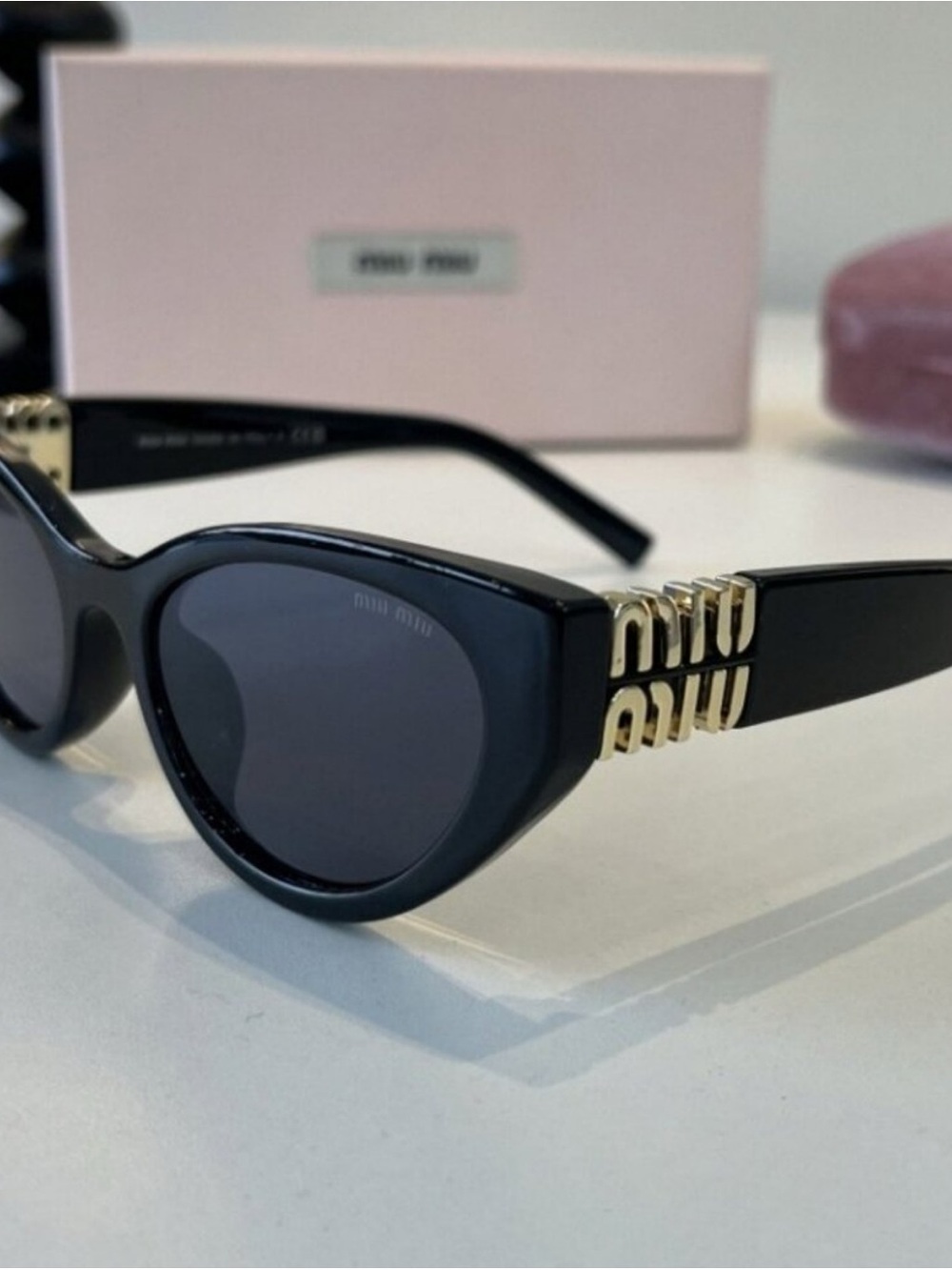 Miu Miu Black Cat-Eye Sunglasses with Gold Accent Detailing